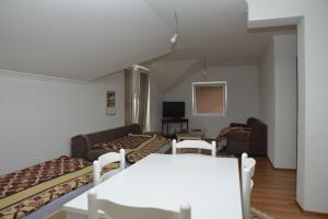 a living room with two beds and a couch at Apartmani Previja in Berane