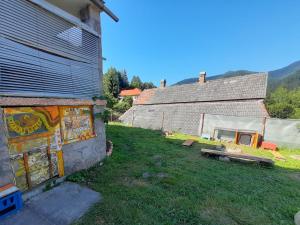 a building with a mural on the side of it at Welcome to Snad in Băile Tuşnad