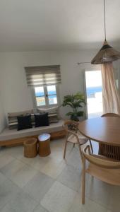 a living room with a couch and a table at Evdokia - Luxury Olive Yard apartment with Aegean View in Moutsouna Naxos