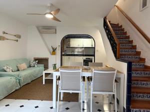 a living room with a table and chairs and a staircase at Varadero Calma in Santa Pola