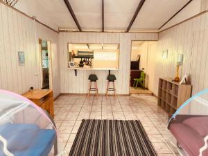 a living room with two stools in a room at Fare Om in Pihaena