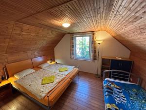 - une chambre avec un lit et un plafond en bois dans l'établissement Chalupa Měňany - Karlštejn, à Beroun