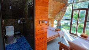 a small bathroom with a shower and a toilet at Phu Nam House - Resort in Phú Quốc