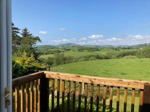 a balcony with a view of a green field at Welsh wonderland in Builth Wells