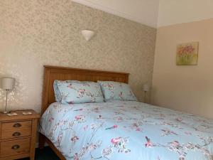 a bedroom with a bed with a blue comforter at Welsh wonderland in Builth Wells