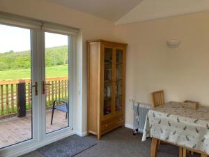 a room with a table and a sliding glass door at Welsh wonderland in Builth Wells