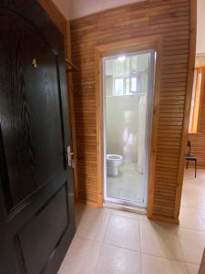 a door leading to a bathroom with a toilet at Guest house Shekvetili in Shekhvetili