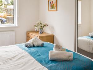 a bedroom with two towels on a bed at Puffling in Falmouth