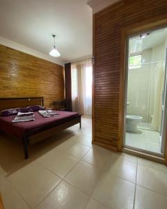 a bedroom with a bed and a bathroom with a tub at Guest house Shekvetili in Shekhvetili