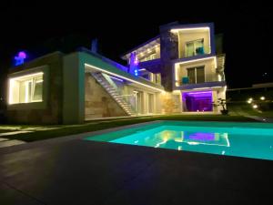 a house with a swimming pool at night at Villa Rocca - Rooms&SPA in Pizzo