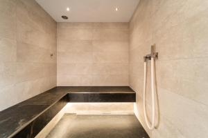 baño con banco y ducha en Hôtel du Glacier, en Champex