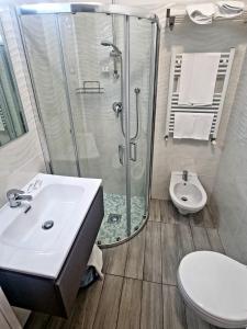 a bathroom with a shower and a sink and a toilet at Hotel Mare Blu - Bed & Breakfast in Pineto +101 photos