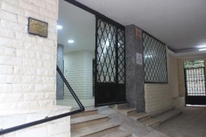 a staircase in a building with a black door at Agouza NileView Apartment in Cairo