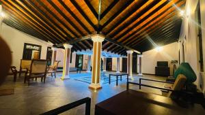 a large living room with a wooden ceiling at Flamingo Village in Jaffna