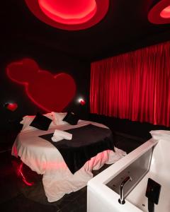 a bedroom with a bed with a red heart on the wall at Meeting Hotel in Casoria