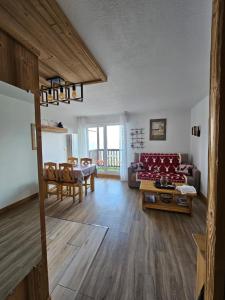 a living room with a couch and a table at LES BALCONS DU SOLEIL L OURSON in Font Romeu Odeillo Via