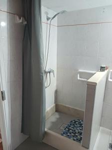 a bathroom with a shower with a shower curtain at Fairytale in Boïkátika +37 photos