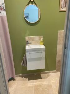 a bathroom with a sink and a mirror at GITE DE FAMILLE in Dieppe +25 photos