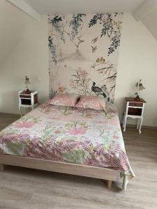 a bedroom with a bed and two tables and a wall at GITE DE FAMILLE in Dieppe