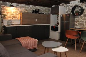 eine Küche und ein Wohnzimmer mit einem Sofa und einem Tisch in der Unterkunft Theane lime 1 in Kavala