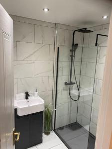 a bathroom with a sink and a shower at Perfectly situated luxury 2 bedroom apartment in Glasgow