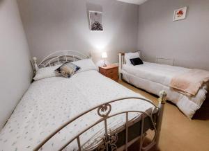 a bedroom with two beds in a room at Farm View Cottage Castlerea in Castlerea