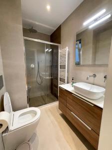 a bathroom with a toilet and a sink and a shower at Iris in Athens