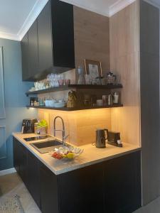 a kitchen with a sink and a counter top at Apartament Morska 5-4 in Darłowo