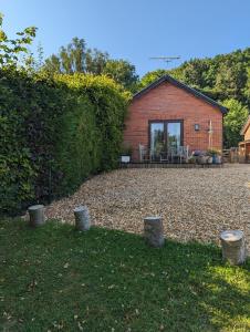 a brick house with a patio in the yard at Little Chilsbury in Potterne