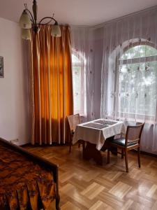 una sala da pranzo con tavolo, sedie e finestra di Spacious rooms in peaceful Jelgava area a Jelgava