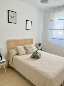 a bedroom with a large bed in a room at Apto Olta 3 centro Campello piscina wifi parking in El Campello