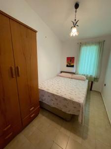 a small bedroom with a bed and a cabinet at Huge Villa 300 meters to sea and near to Ida mount in Burhaniye