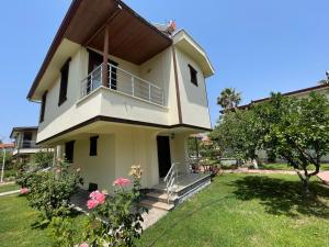 a house with a balcony and a yard at Huge Villa 300 meters to sea and near to Ida mount in Burhaniye