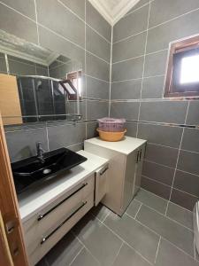 a small bathroom with a sink and a mirror at Huge Villa 300 meters to sea and near to Ida mount in Burhaniye