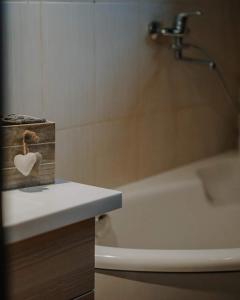 a bathroom with a bath tub and a box with a heart on it at Rīti Siguldā in Stīveri +44 photos