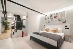a bedroom with a large bed and a staircase at dobohomes - GC21 in Madrid