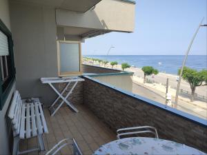 a balcony with a bar with a view of the beach at Terrace on the sea in Roccalumera
