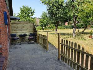 a fence with chairs and a table on a patio at Lighthouse in Drage