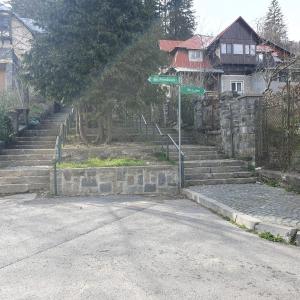 a street sign sitting on the side of a road at Moonlight-House Dark Side Apartment in Sinaia +15 photos