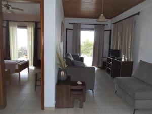 a living room with a couch and a table at Germanis House in Agios Ioannis Pelio