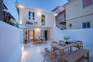 a patio with tables and chairs on a building at Angestrale Wood in Lefkada Town