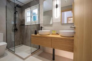 a bathroom with two sinks and a glass shower at Angestrale Wood in Lefkada Town +52 photos