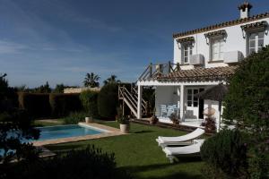 a villa with a swimming pool and a house at Casa La Siesta in Vejer de la Frontera
