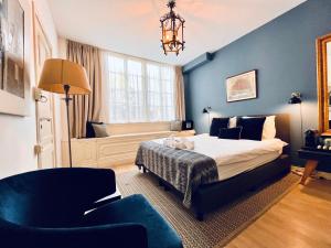 a bedroom with a bed and a chair and a window at Patrick's Place in Amsterdam