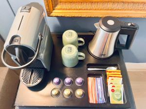 a coffee maker and other items on a table at Patrick's Place in Amsterdam