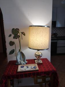a lamp sitting on top of a table with a book at APE REGINA Rignano extension in Rignano Flaminio