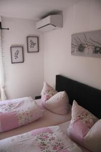 a bedroom with two beds with pink pillows on them at Fewo Weinland in Zweibrücken