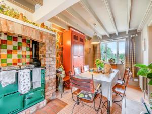 a kitchen with a table and a brick wall at Crown Gardens in Rosedale Abbey