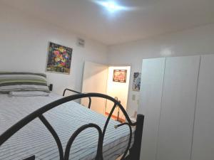 a small bedroom with a bed and a cabinet at Kelys Transient San Pablo Laguna in San Pablo