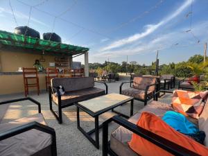 a group of chairs and tables on a patio at Del Cielo Serviced Apartments in Entebbe